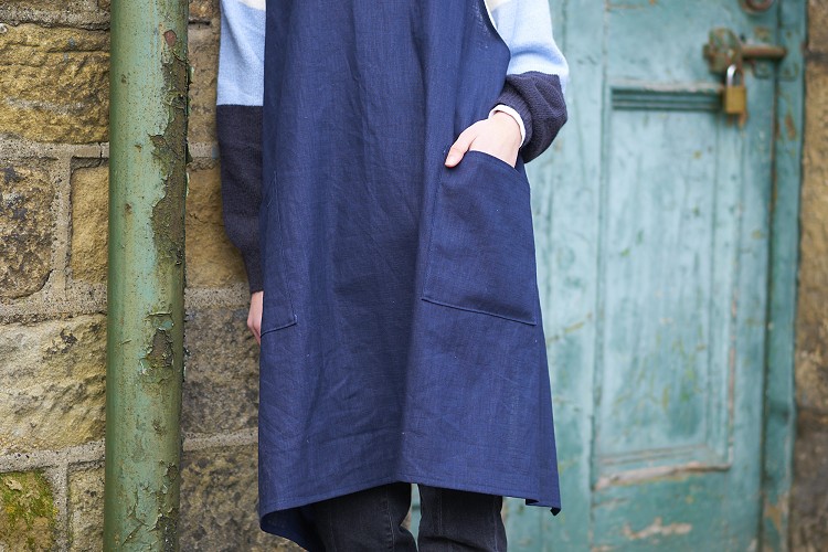 Isabel in a navy linen crossback apron