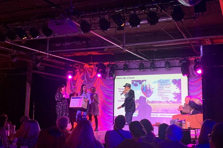 Give away winners on stage at the old woollen