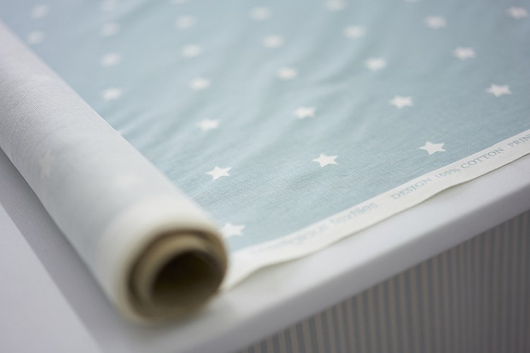 Rolling out Fabric on the cutting table